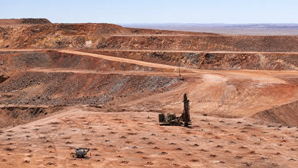 Blast-hole drilling equipment working on an open-pit mine bench